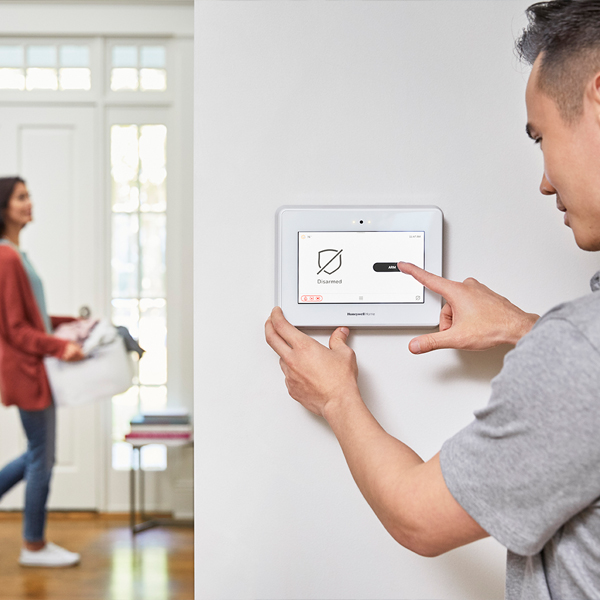 person checking security system in house